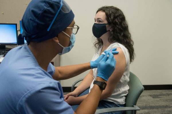 Can I stop wearing a mask after getting a COVID-19 vaccine?